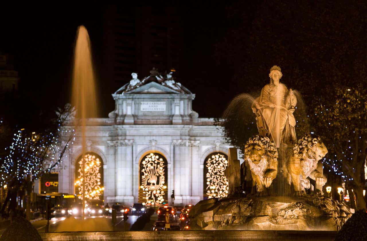 Puerta de Alcalá y fuente de Cibeles por la noche, iluminadas con luces navideñas Madrid