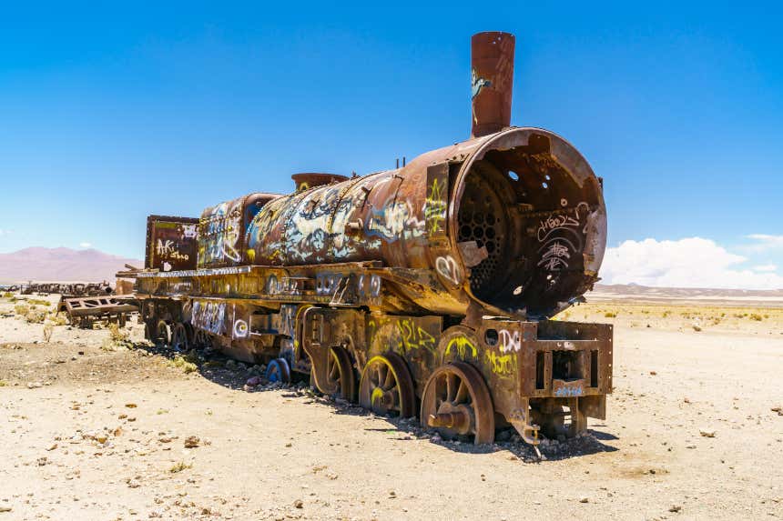 Una locomotora vieja y oxidada descansa abandonada en el salar de Uyuni, en Bolivia