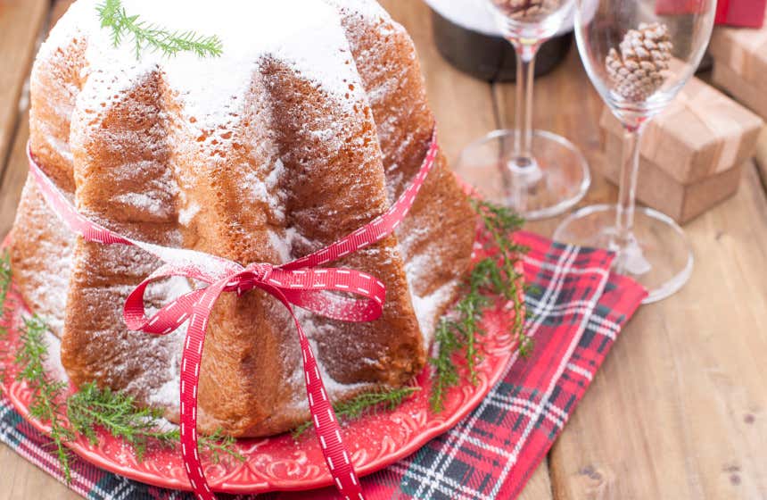 A pandoro, one of Verona's most typical deserts, on a red plate.