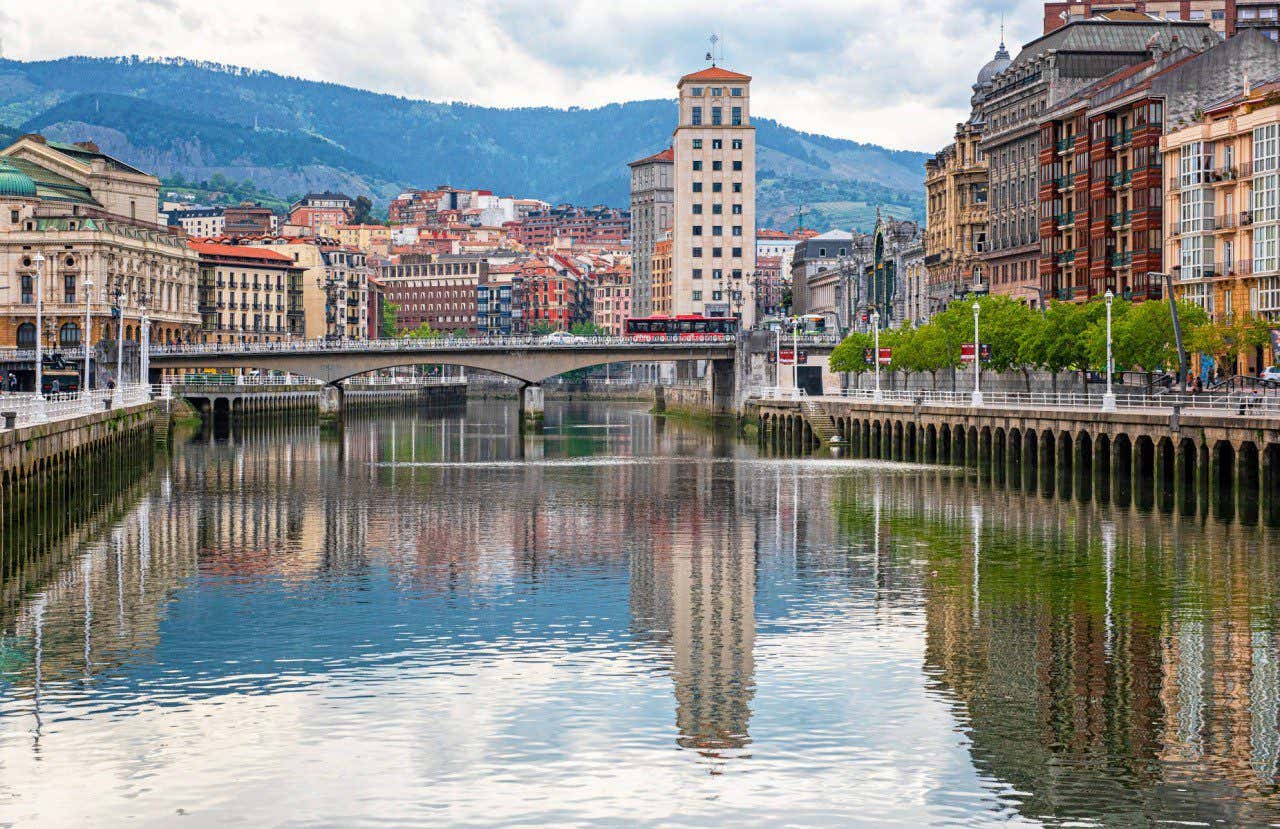 The Estuary of Bilbao lined with colourful buildings and a bridge going across