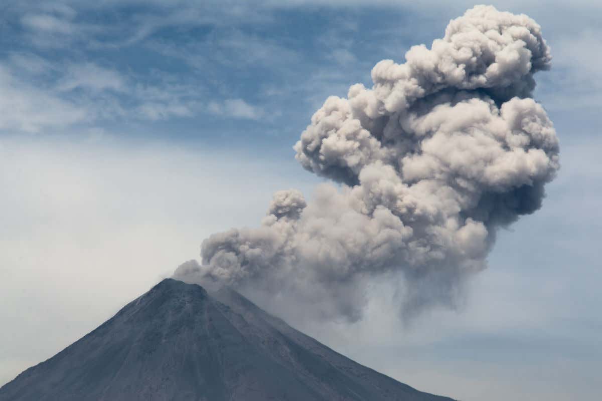 View of the peak of Colima emitting grey clouds of gases in Mexico