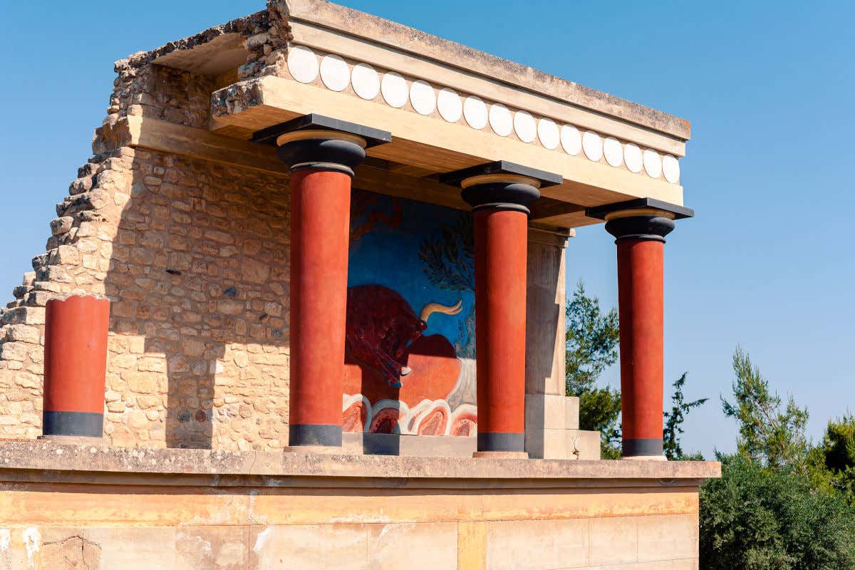 Knossos palace in Crete, with red columns and frescos painted on the walls