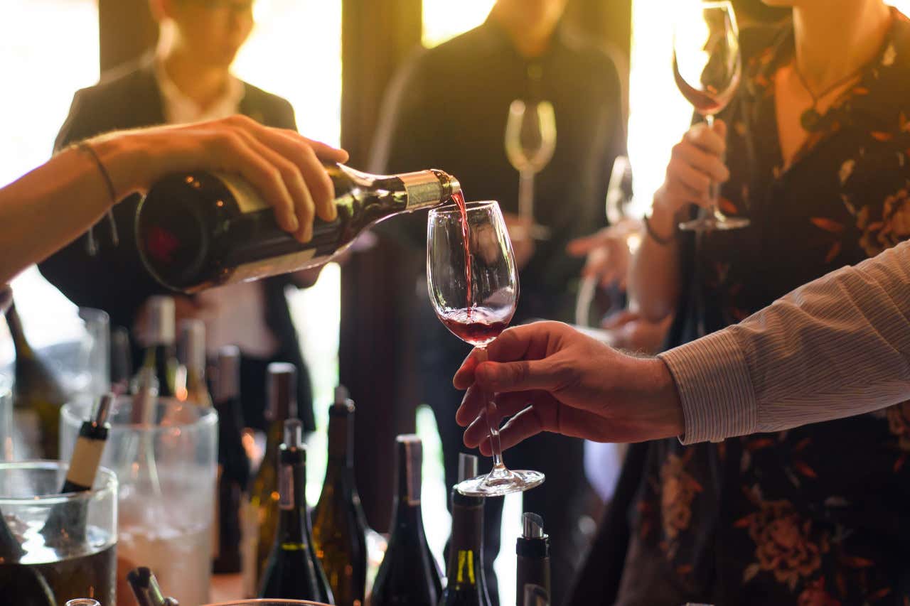 Un grupo de personas celebrando y brindando con copas de vino