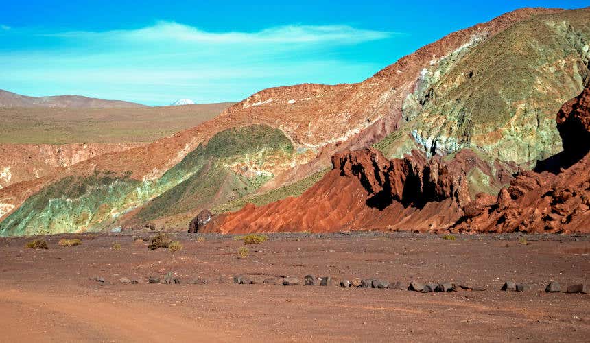 Mountains and cliffs in different shades of green and brown in the Atacama Desert