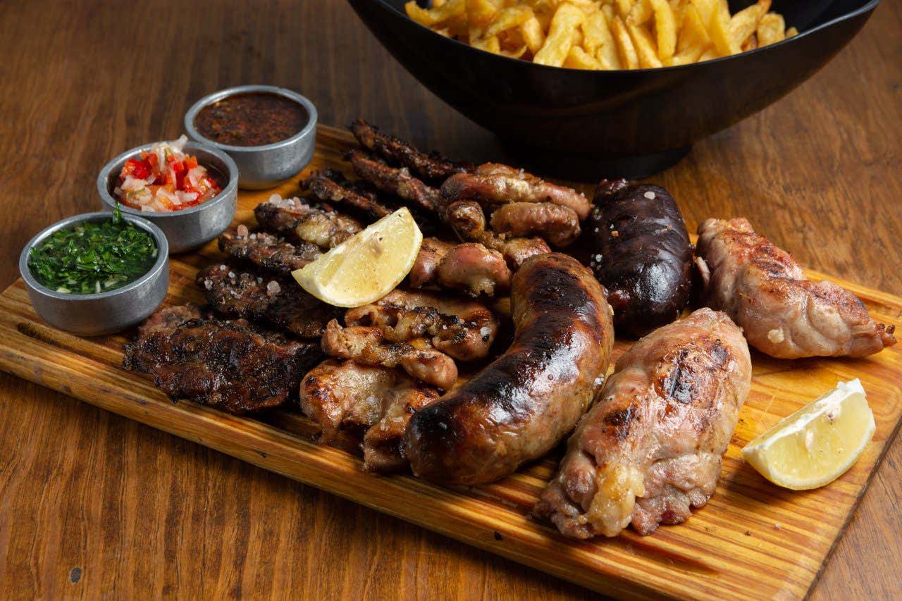 Argentinian asado at Christmas with different grilled meats on a wooden board