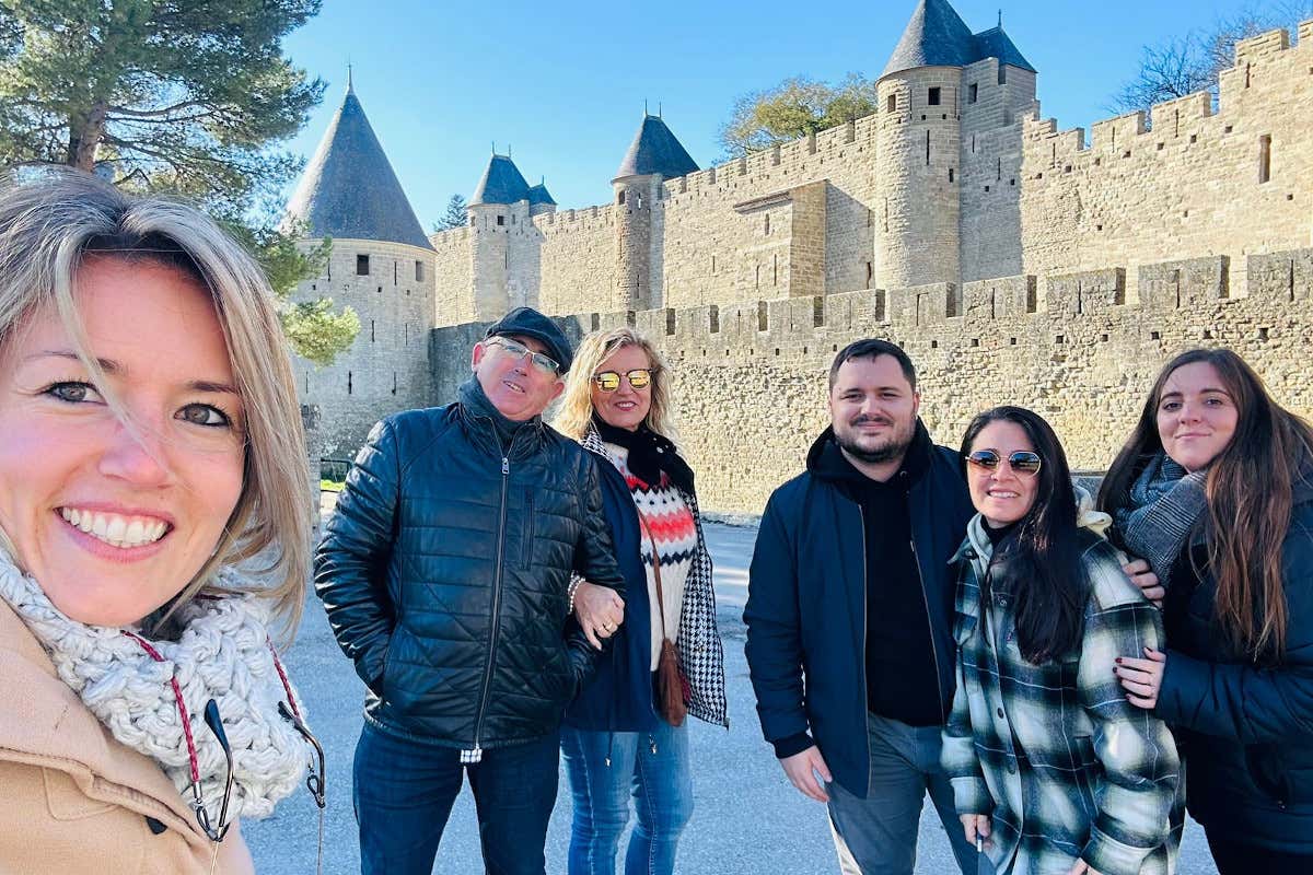 Un grupo de personas posando ante el recinto amurallado de Carcasona, Francia