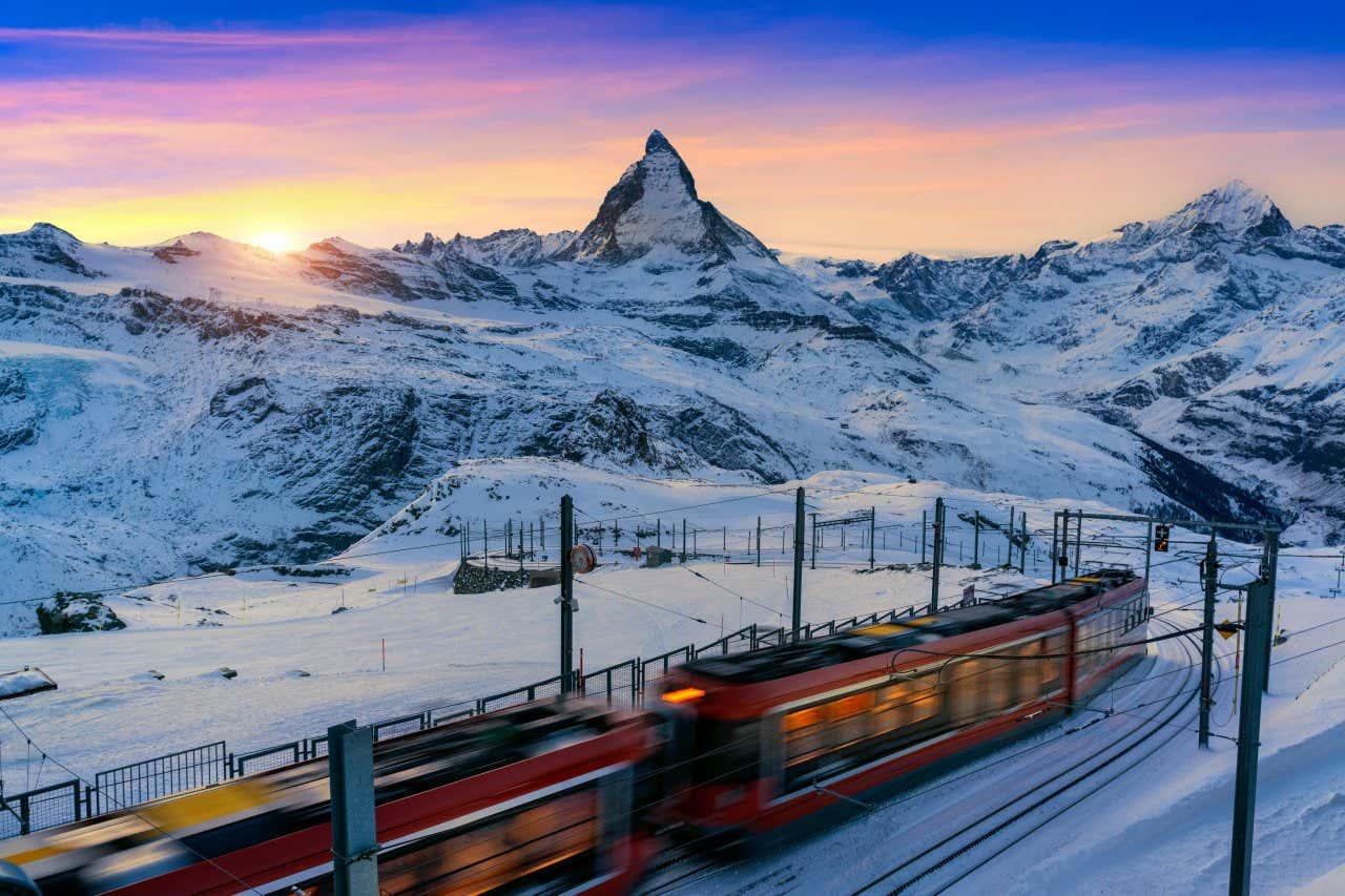Sunset over the snow-covered Matterhorn, with the Gornergrat cogwheel railway in the foreground