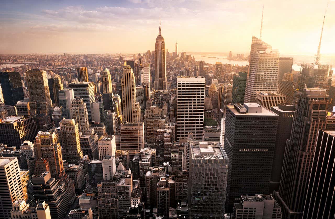 New York City's skyline seen from above as the sun sets, with a number of the largest skyscrapers in view