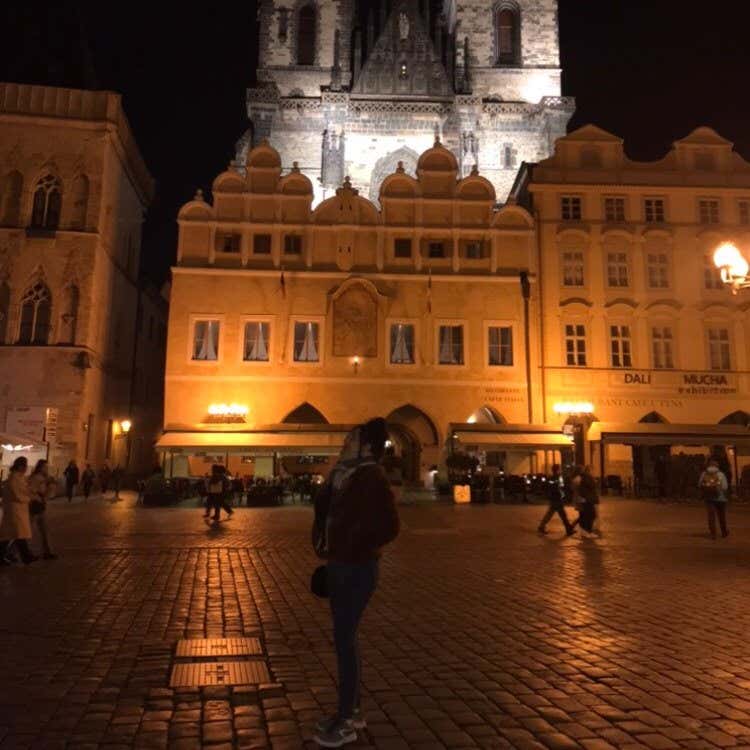 Oumayma posando en la fachada de un edificio histórico de Praga.
