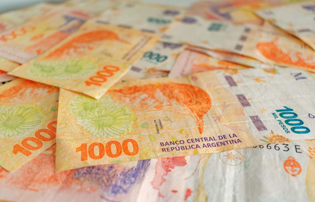 Banconote da 1000 pesos argentini dai colori sgargianti arancioni e gialli