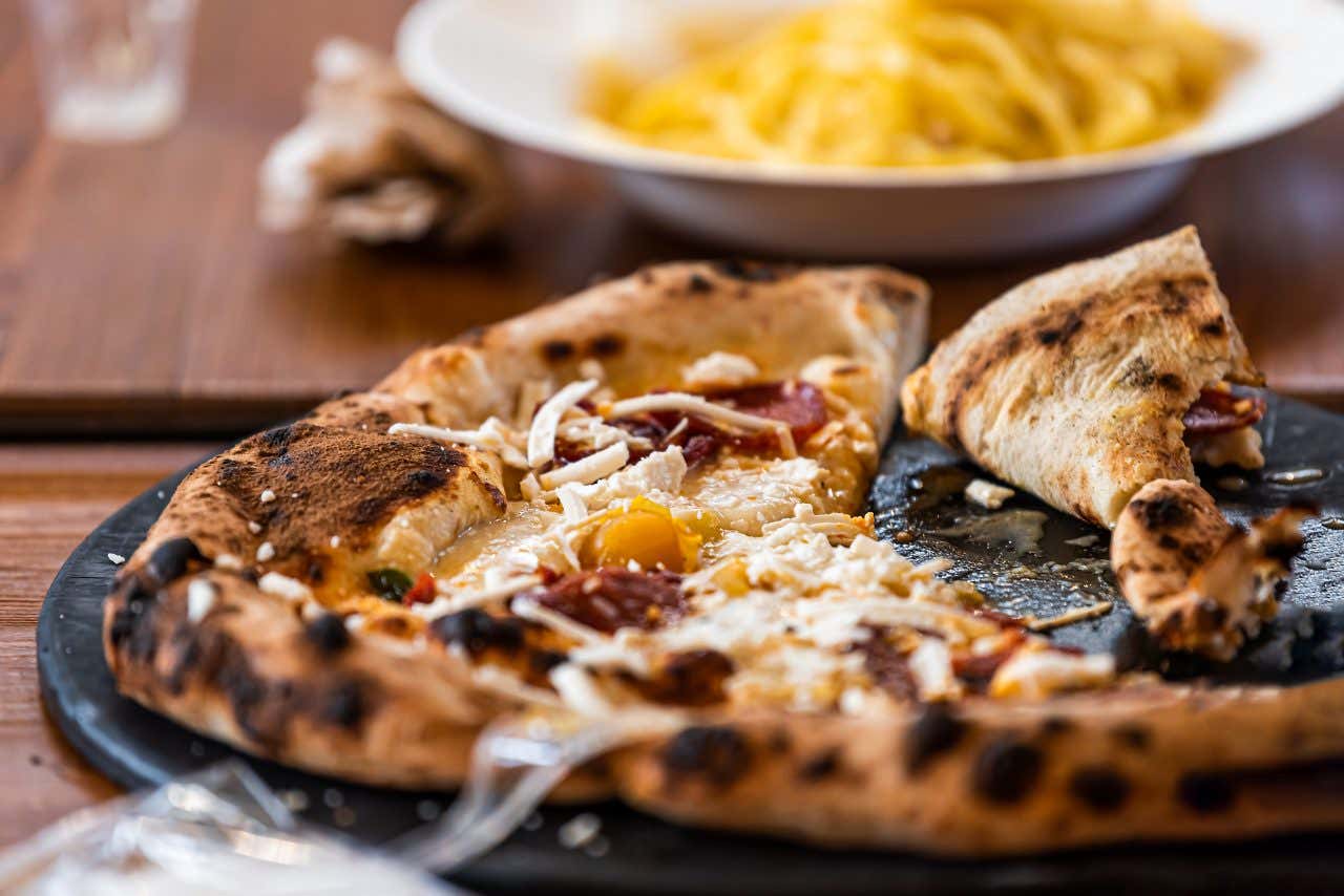 A close-up of a pizza on a black plate