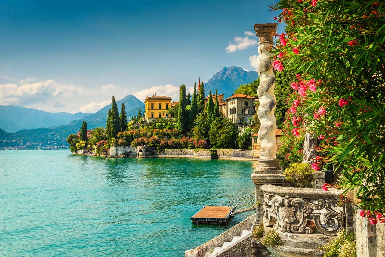 Views of Lake Como with vegetation and the lake and historic buildings in the distance