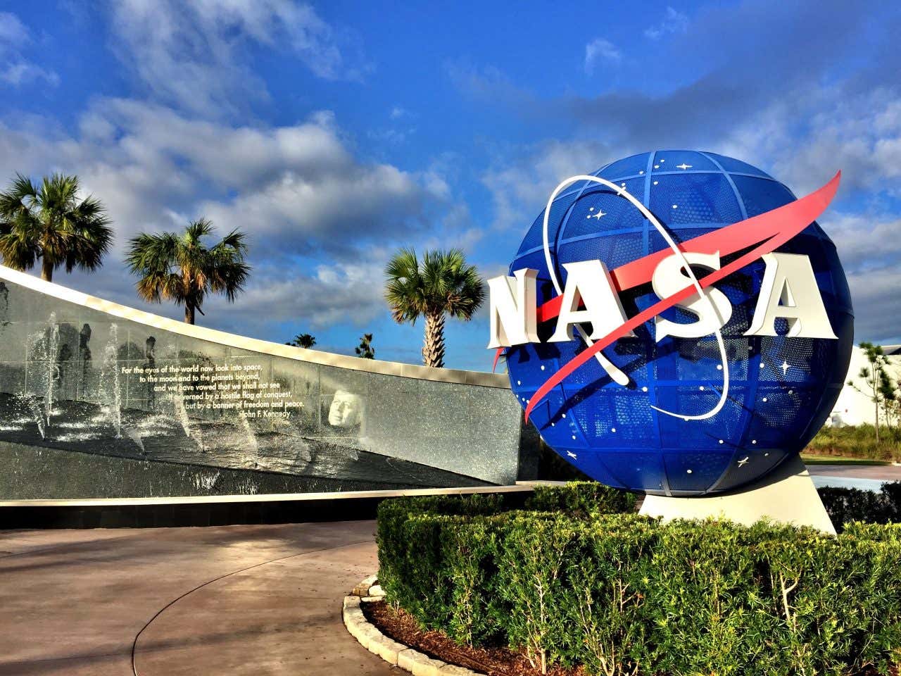 A blue NASA globe at the Disney World Orlando with a cloudy blue sky in the background.