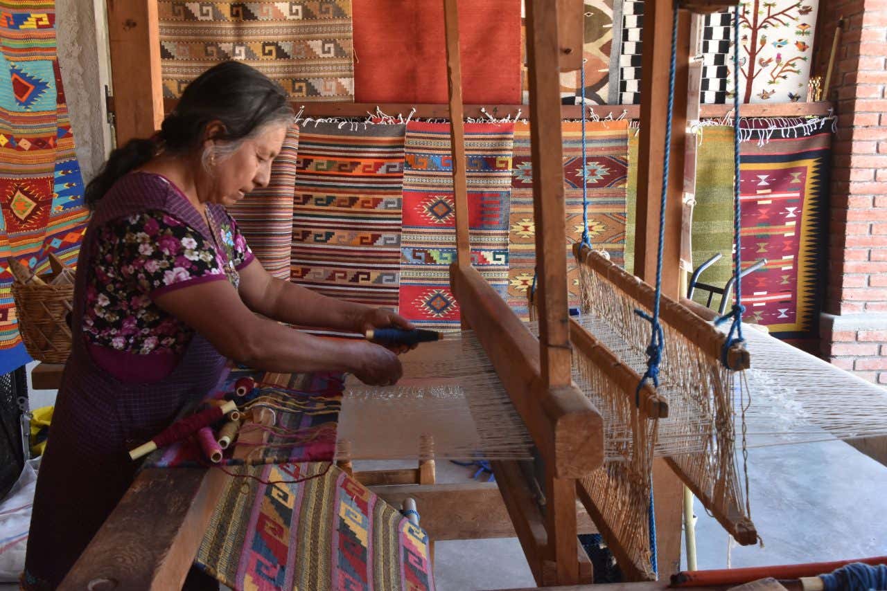 A Oaxacan woman working in a textile workshop.