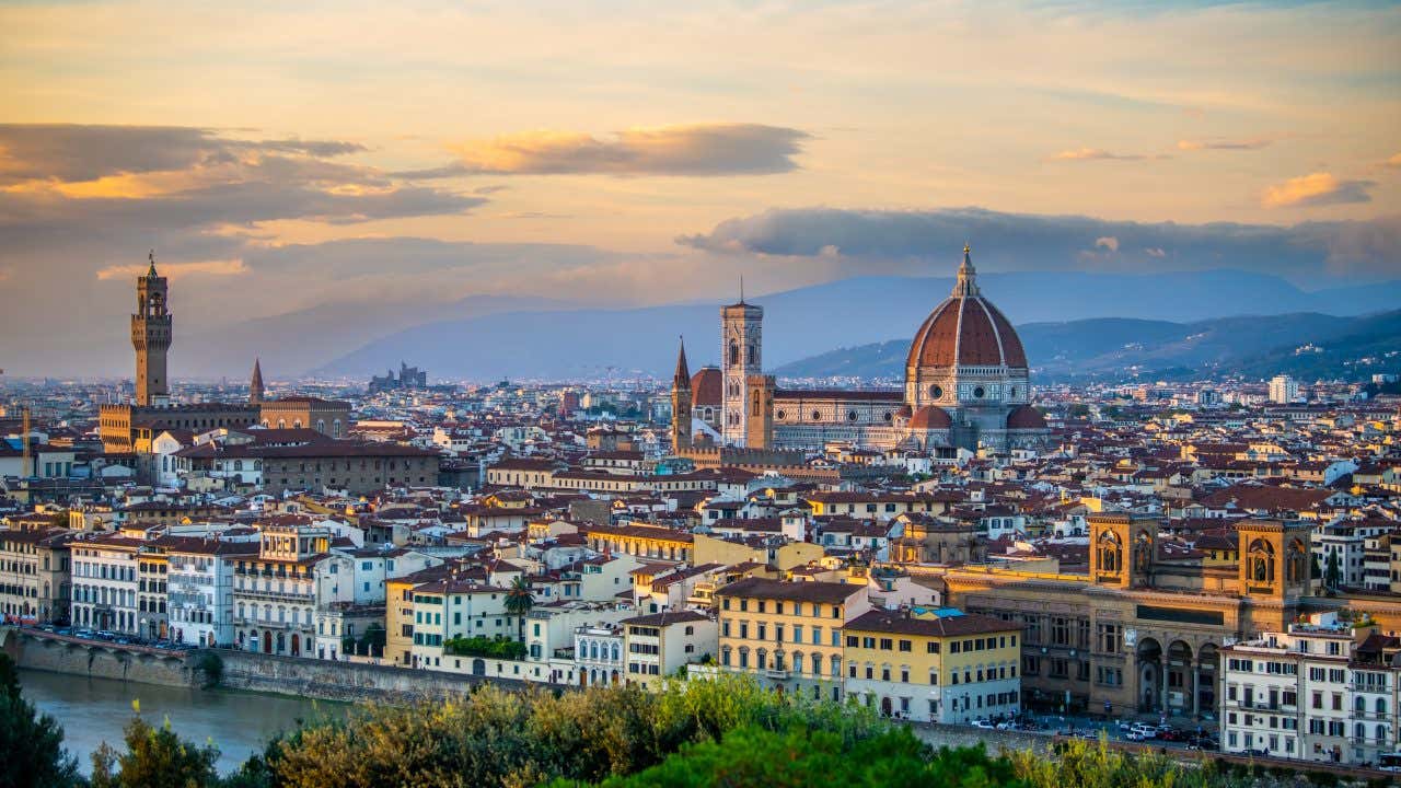 Florence's skyline in the evening with yellow skies.