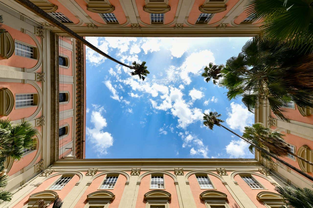 The inner patio of a National Archeological Museum, looking up into the sky.