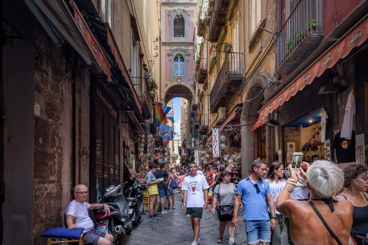 Via San Gregorio in Naples, with lots of people at street level.