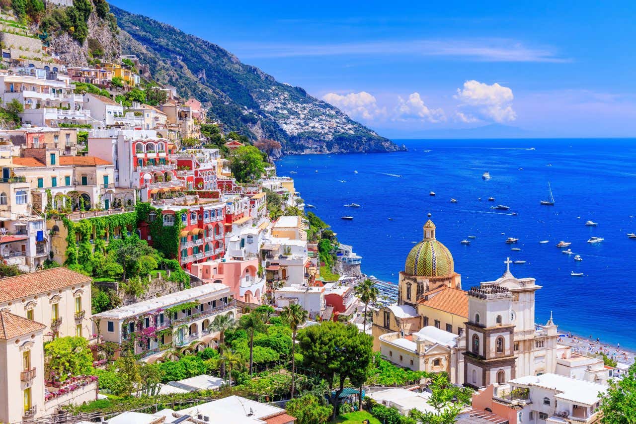 Sea views from Positano, with boats in the water under a clear blue sky.