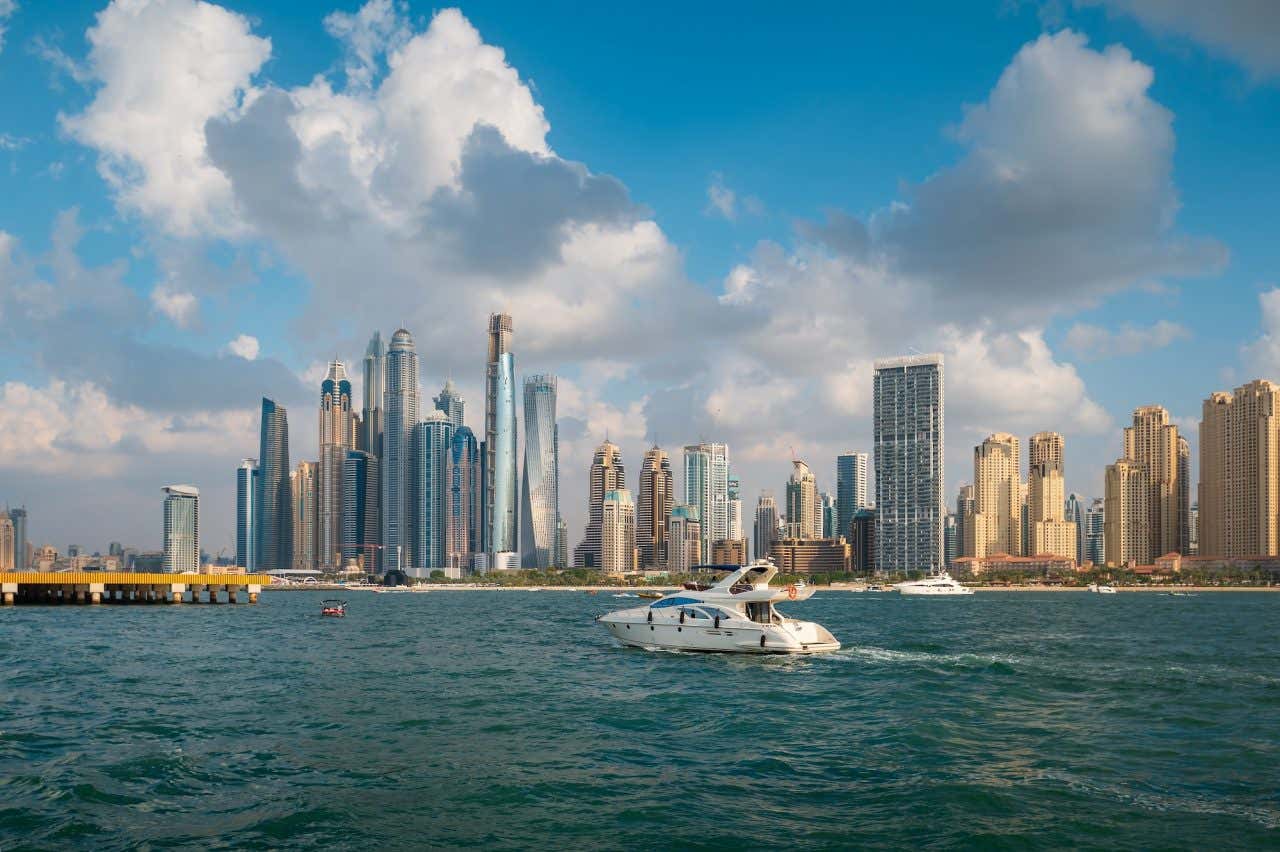 Iate na Dubai Marina com o horizonte do centro de Dubai ao fundo