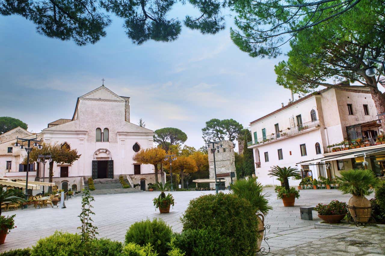 A view of the Duomo di Ravello, with an empty square in front of it, on a clear day.