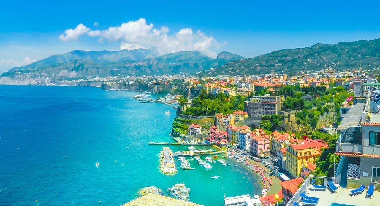 A view of the coast of Sorrento with turquoise waters under a clear blue sky.