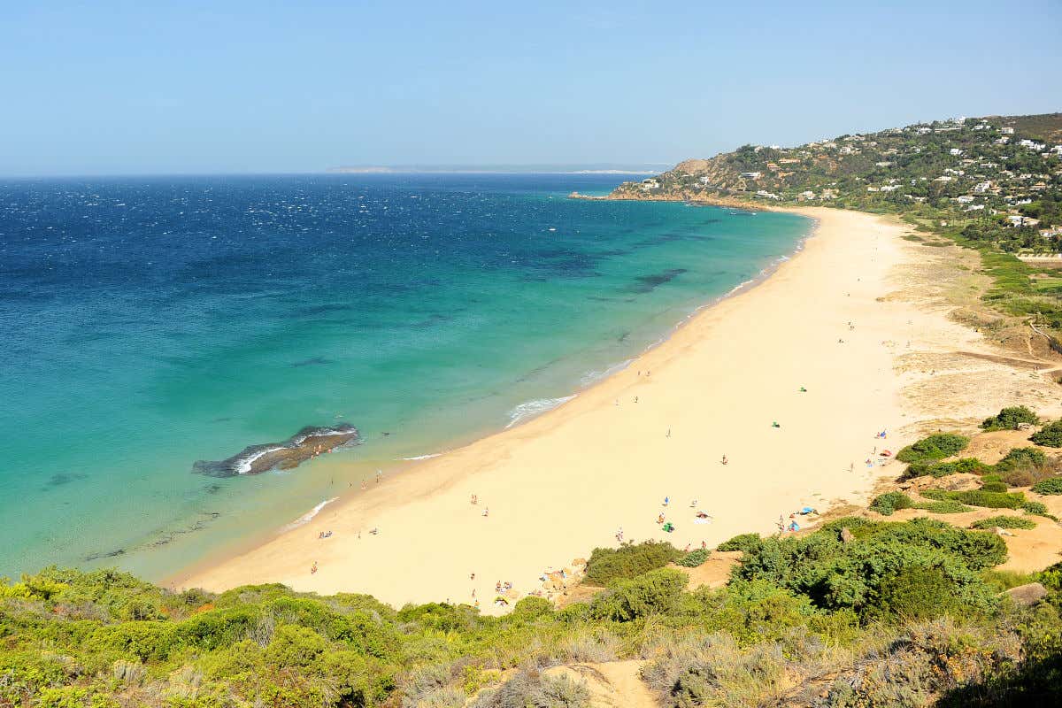 Vista aérea de una playa de arena dorada con mar en calma en Zahara de los Atunes