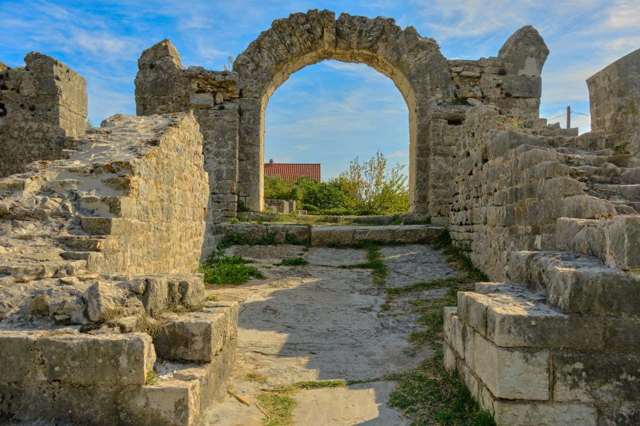 An amphitheater in Saloma near Split, looking through an archway at the blue sky.