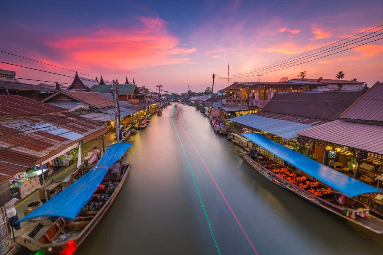 The Amphawa Floating Market in Thailand at sunset.