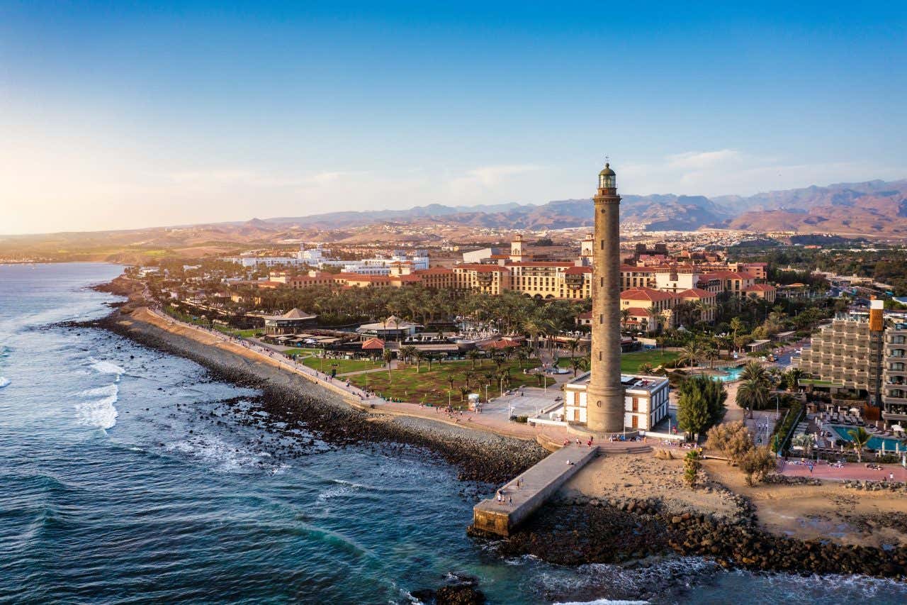 Aerial view of the lighthouse and the city of Maspalomas with the coast.