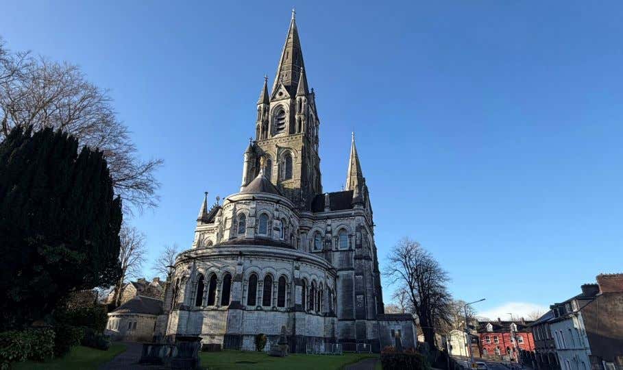 A view of St. Fin Barre's Cathedral under a clear blue sky.