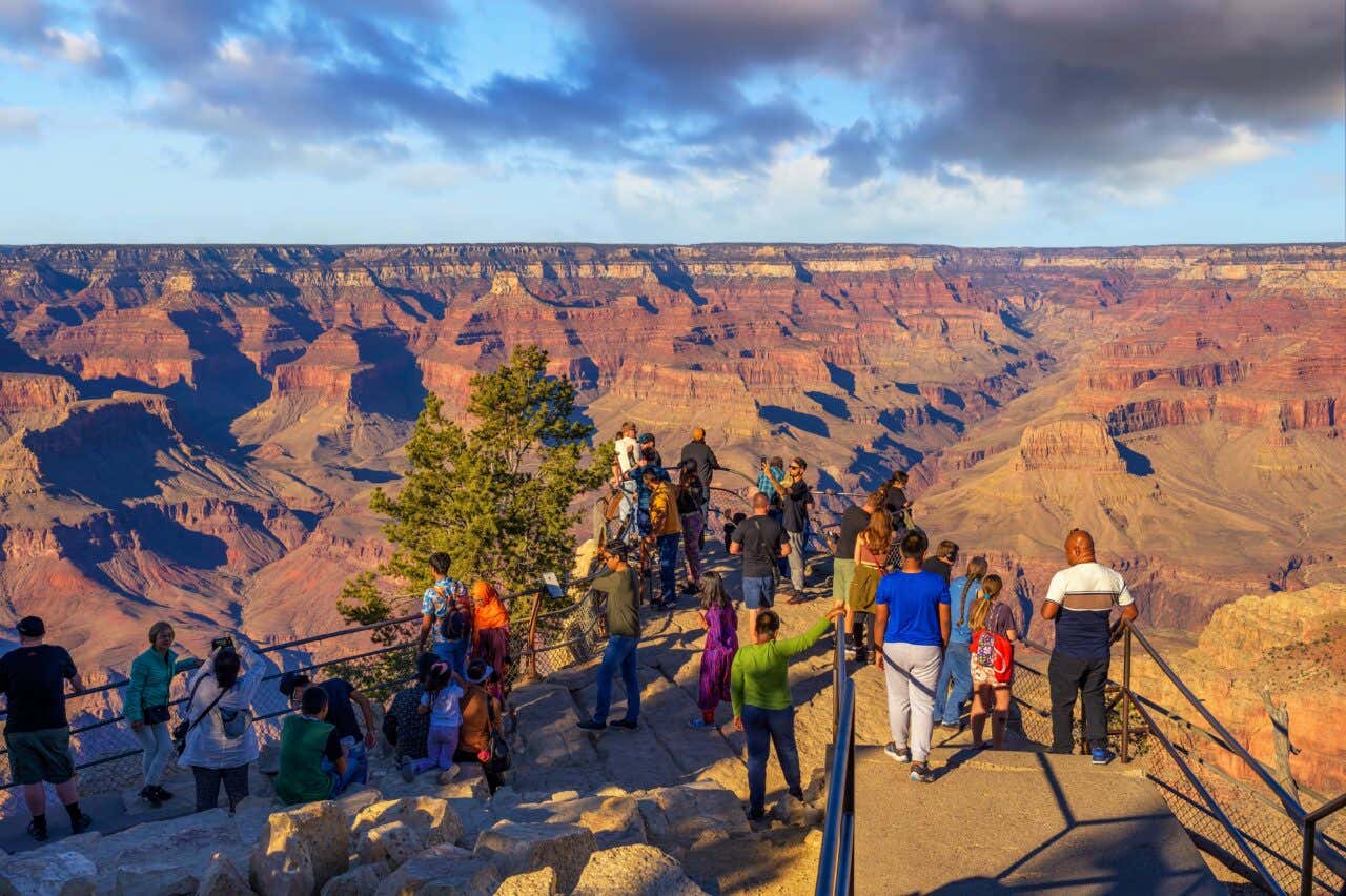 A group of tourists at the edge of the Grand Canyon in Arizona.