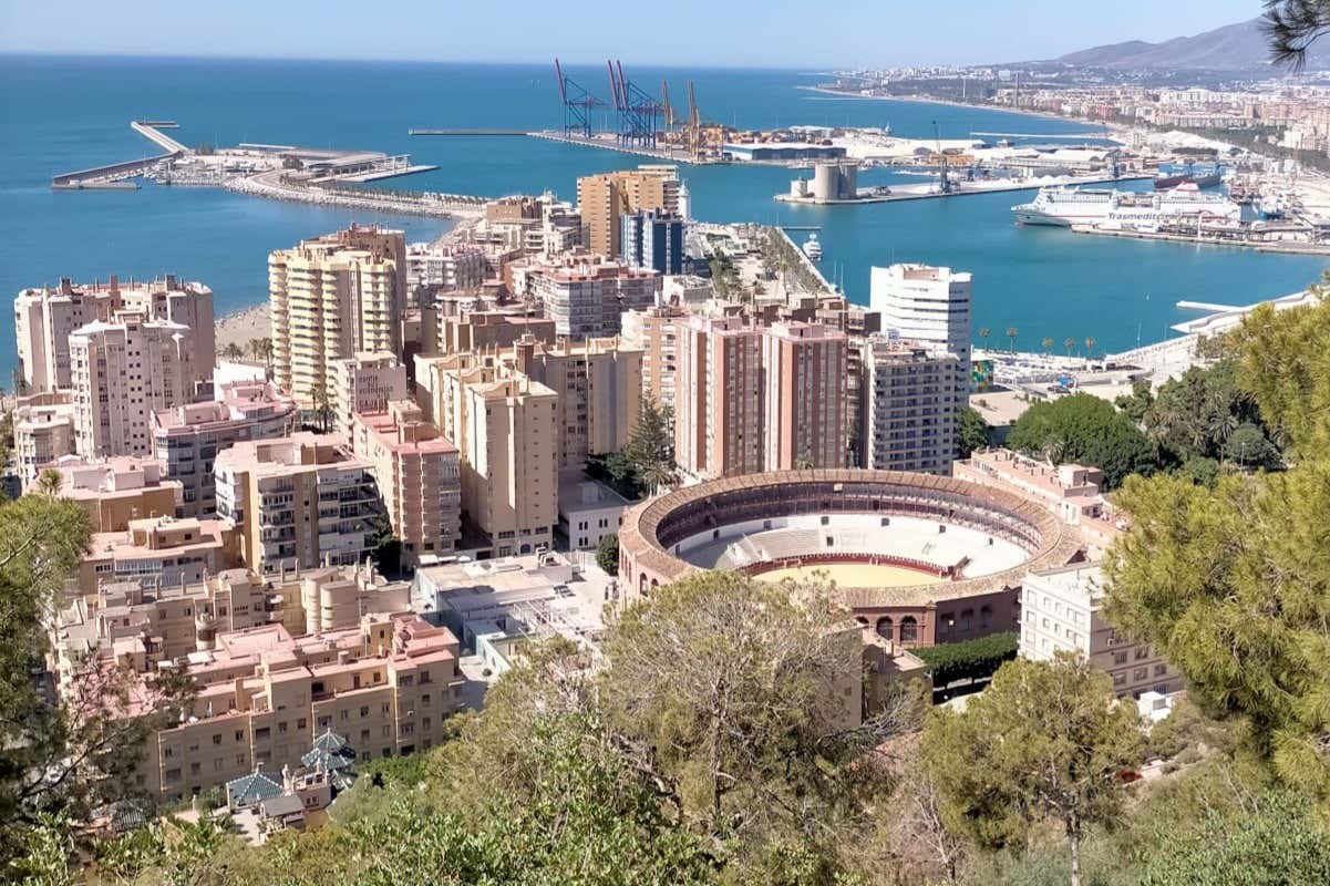 Views of Málaga with tall buildings, its bullring, and the sea
