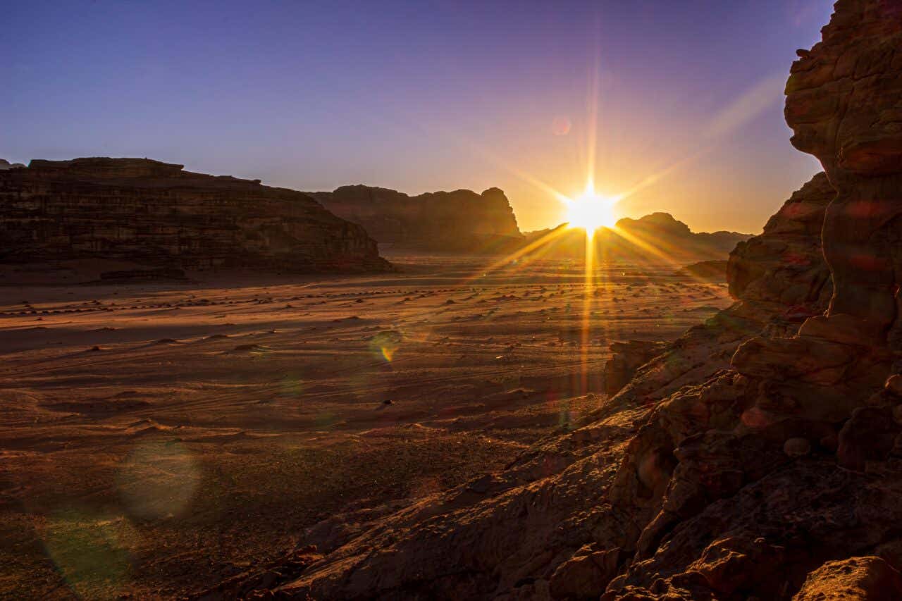 The sun setting over the horizon at Wadi Rum.