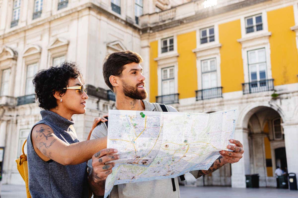 Due turisti con una mappa in una città europea in estate