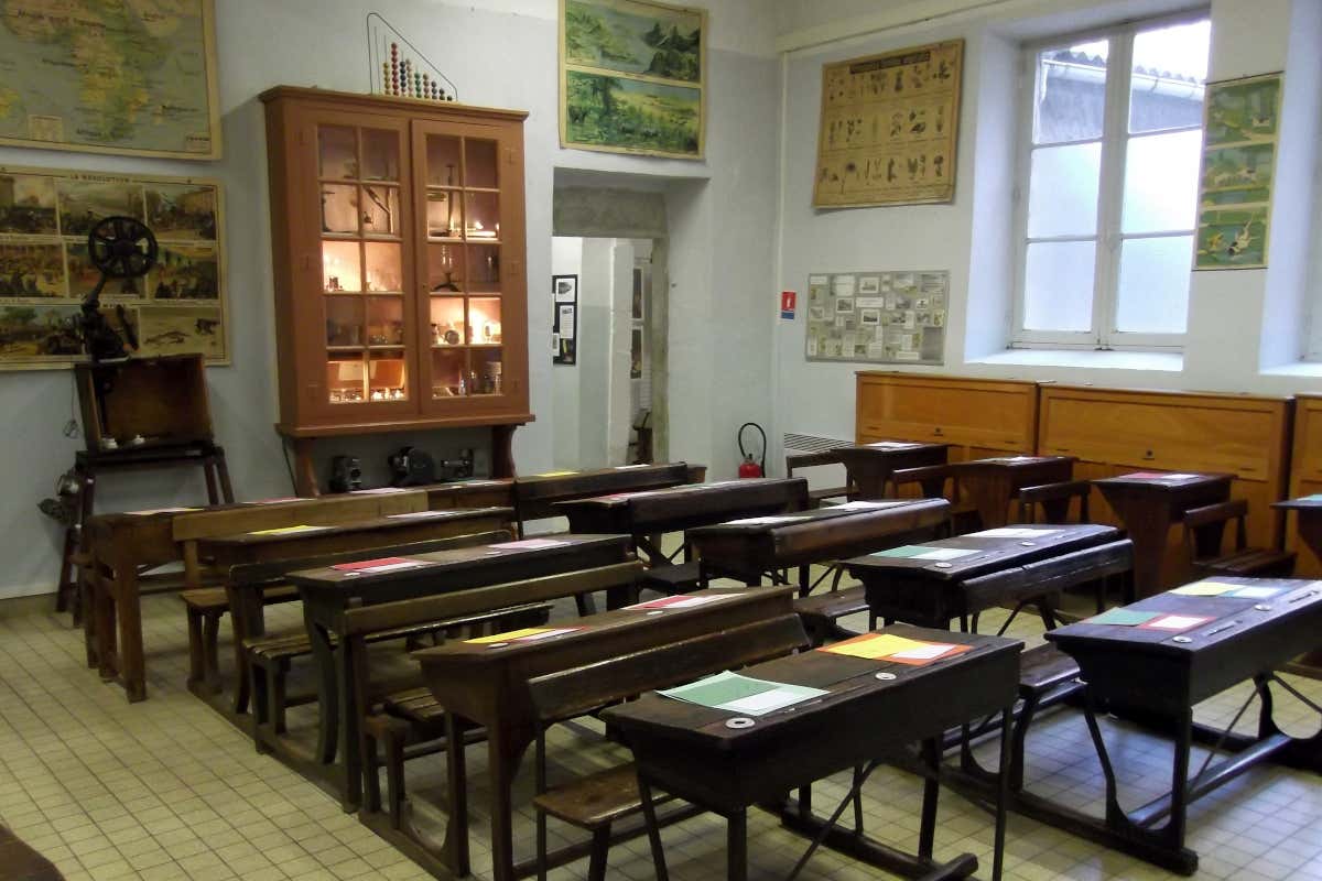 Pupitres de madera en un museo que recrea cómo eran los colegios de mediados del siglo XX