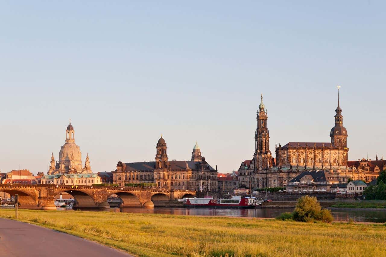 Dresden as seen from across the river Elbe, with a clear blue sky in the background.