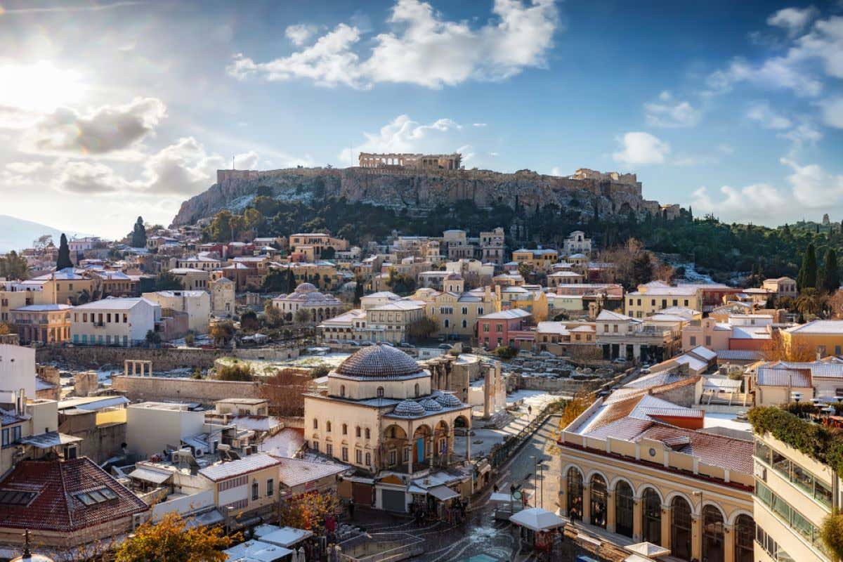 Views of the old town of Plaka in Athens, with the Parthenon in the distance.