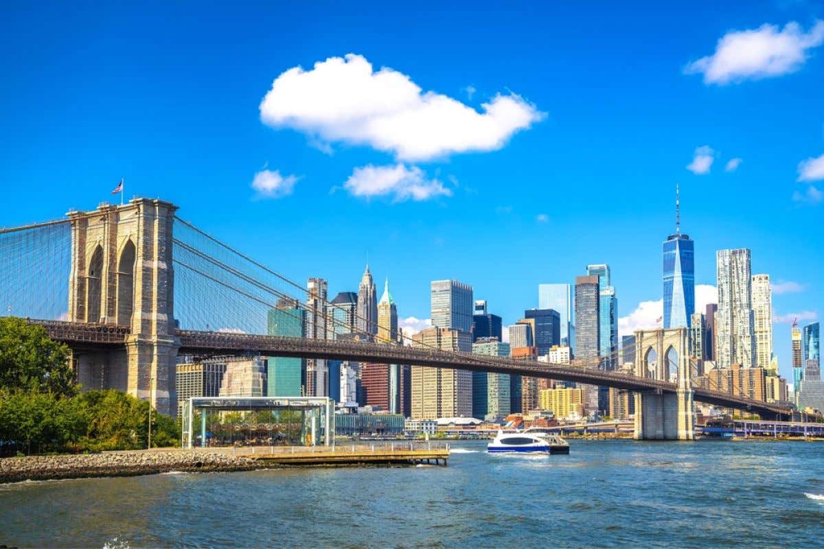 Views of the New York skyline with the Brooklyn Bridge on a sunny day.