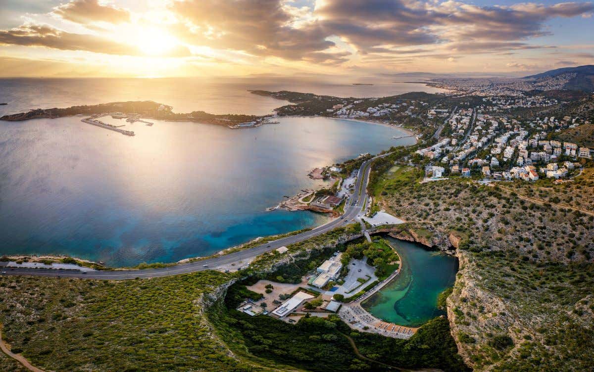 Aerial view of the Vouliagmeni district in southern Athens, Greece, featuring Lake Asteras and the Asteras Peninsula at sunset