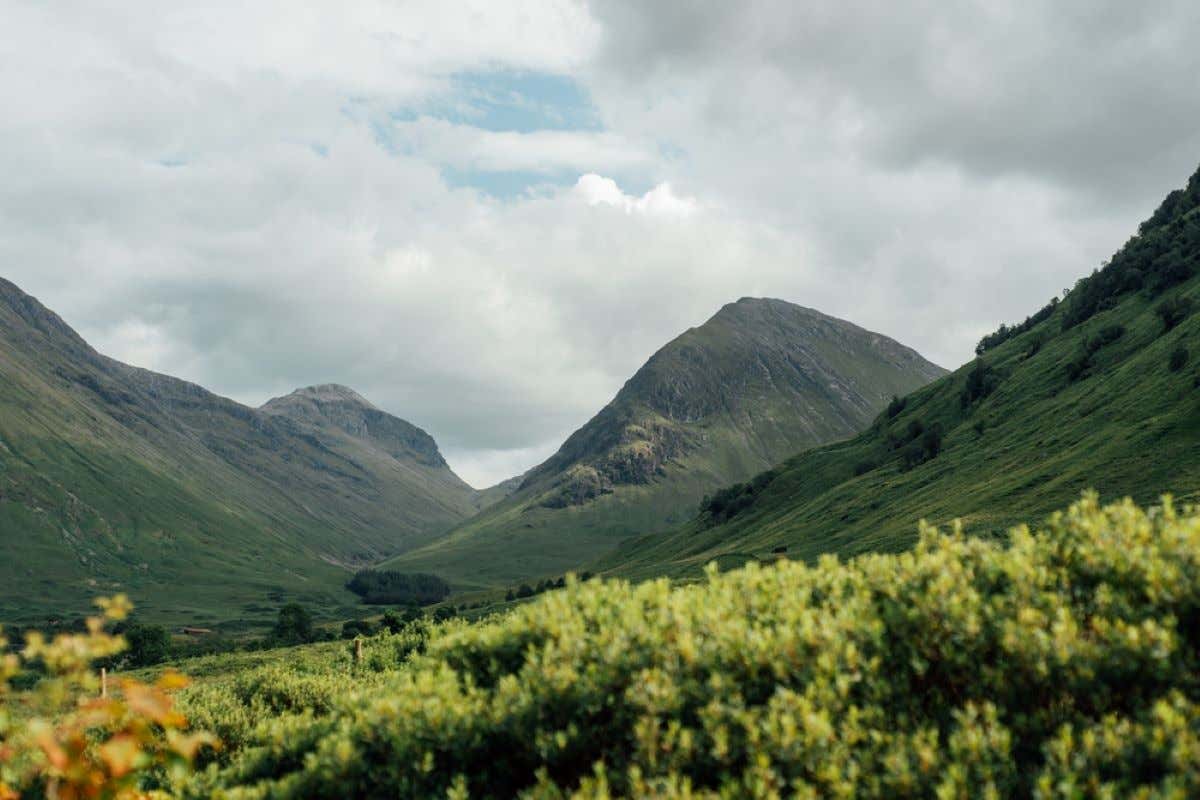 Landscapes of the Scottish Highlands on a partly cloudy day.