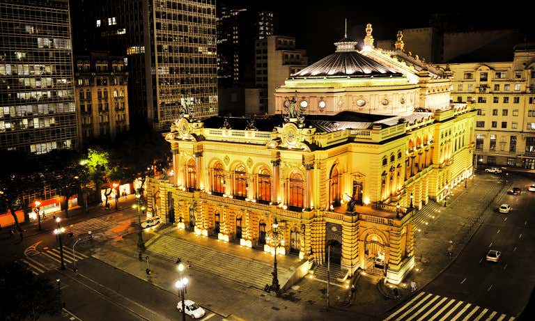 Theatro Municipal de São Paulo iluminado à noite, destacando sua arquitetura histórica no centro da cidade