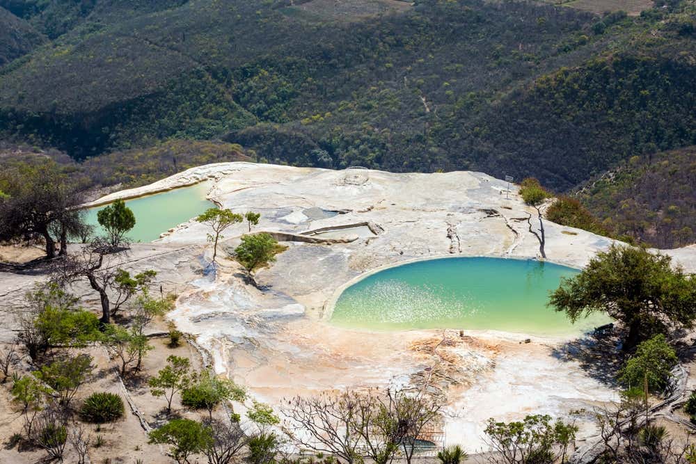 Hierve el Agua, Oaxaca with green vegetation in the background.