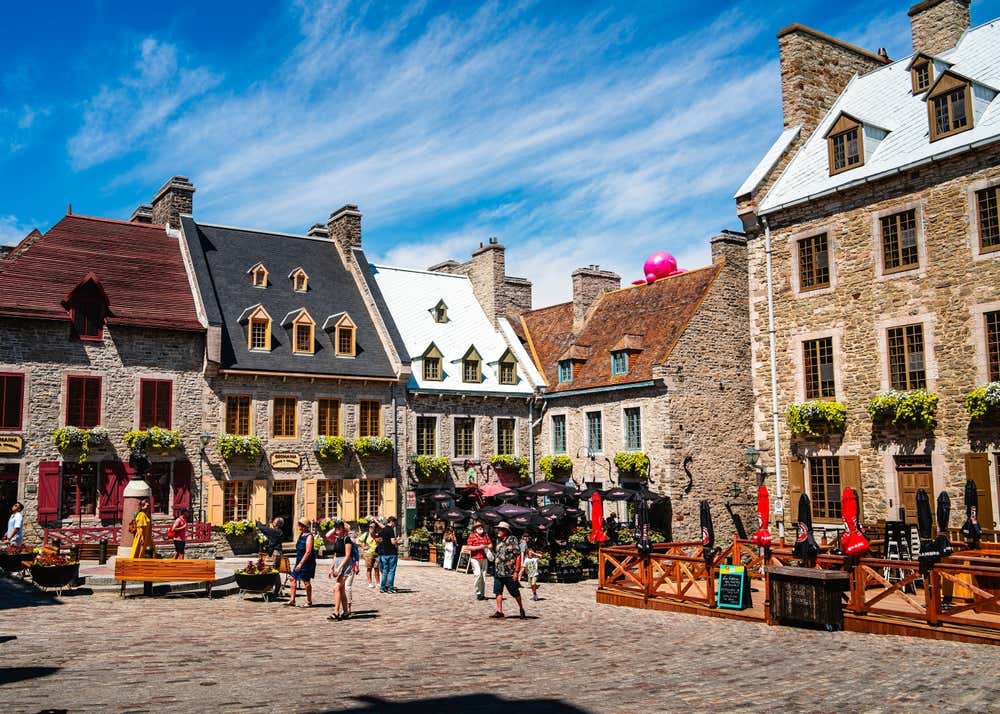 Old Quebec in Quebec, with tourists and locals wandering in the foreground.