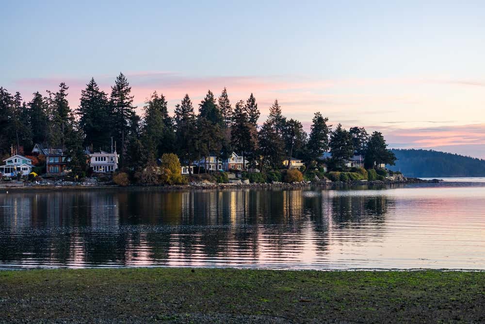 Vancouver Island in British Columbia in the evening, with a pink and blue sky in the background.