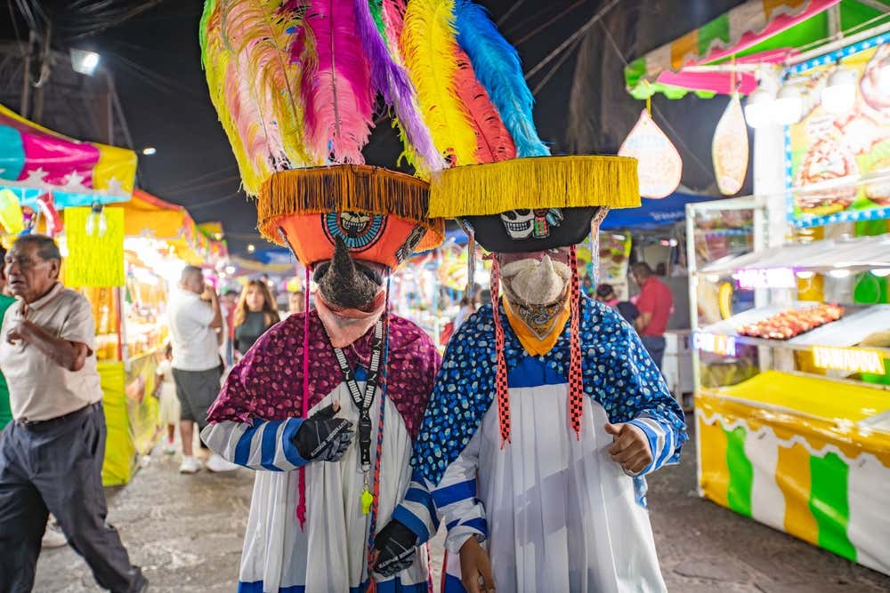 Two people wearing colorful dress in Tlayacapan.