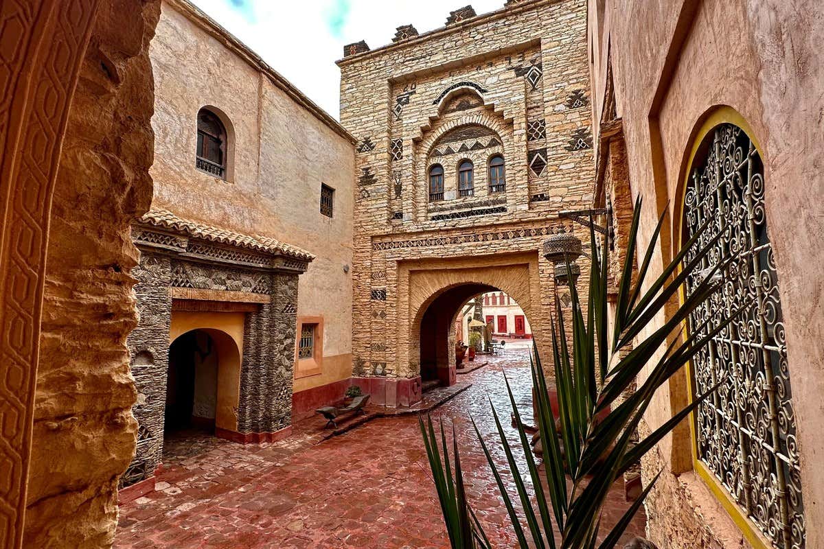 Patio con arquitectura bereber de piedra tallada y arco de entrada ornamentado