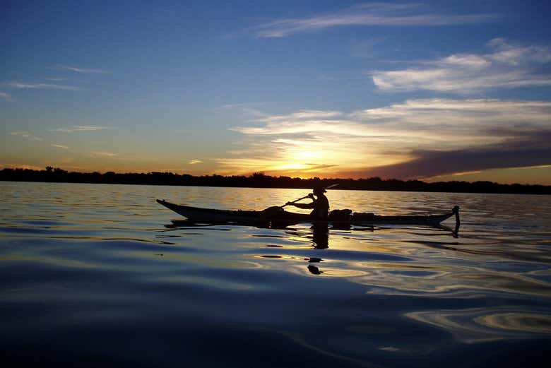 Navegando de caiaque ao entardecer