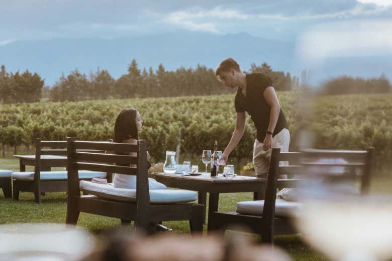 Tomando una copa de vino en el exterior de la bodega
