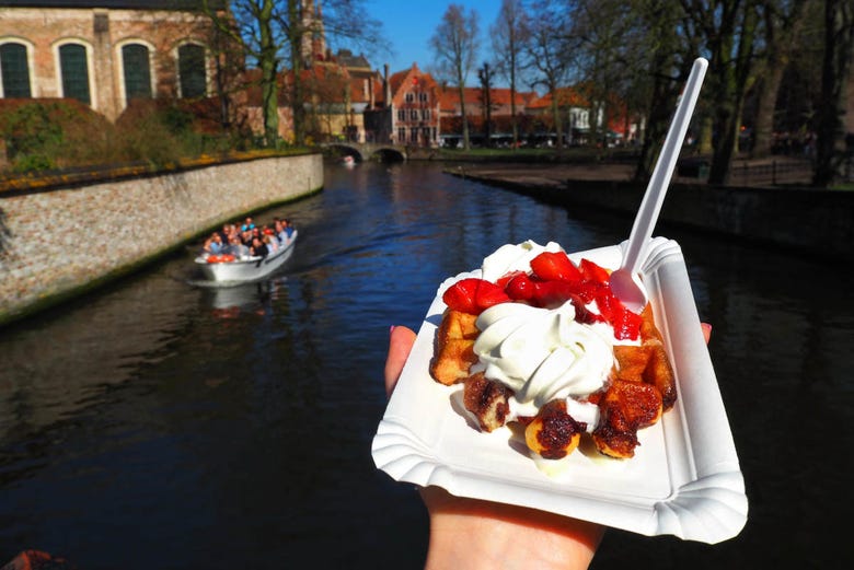 Enjoying a Belgian waffle and views of Bruges' canals