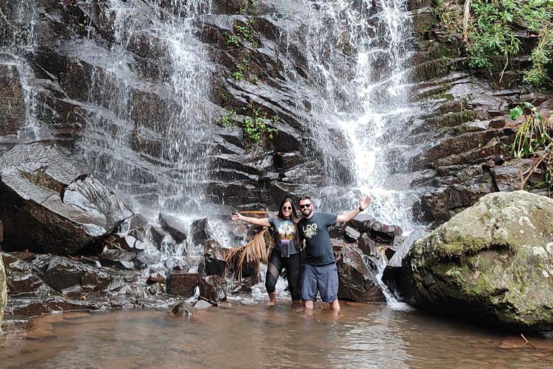 Swim next to a waterfall